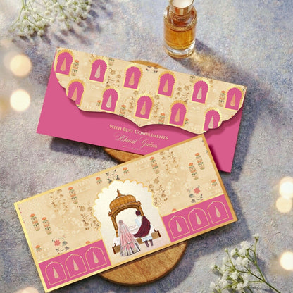 Two decorative envelopes with a pink border and a small bottle of perfume on a textured surface.