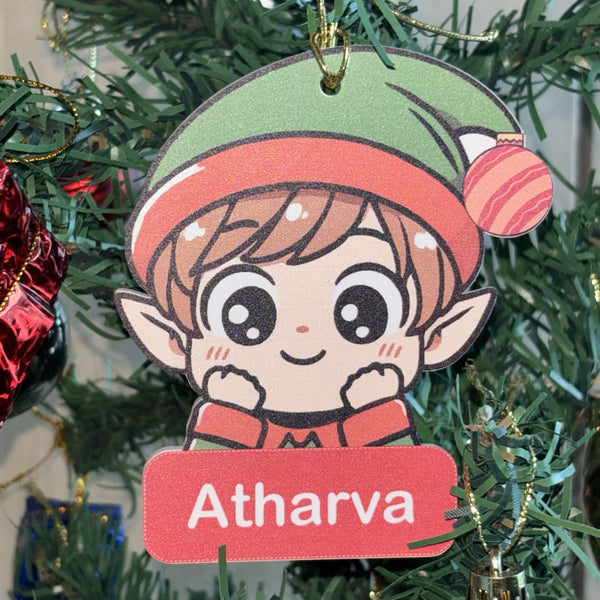 Christmas ornament with a cartoon elf character and 'Atharva' label on a tree.