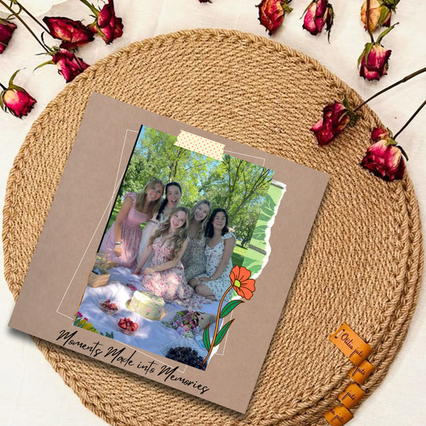 Memorabilia album with a photo of a group at a picnic, surrounded by dried flowers on a woven mat.